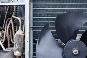 Commercial HVAC system components featuring a large fan and copper tubing, relevant to Diamond Air Design's services in Pensacola.